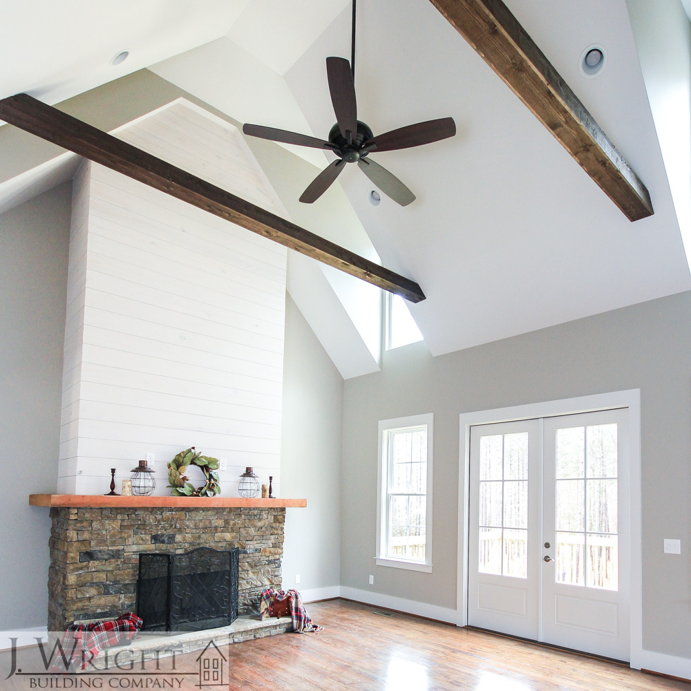 Volume ceilings and cozy fireplaces are common in JWright Building Company floor plans.